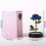 Blue foil rose in a glass dome shown beside a pink gift box with measurements