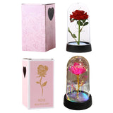 Multicolour galaxy rose in a glass dome shown beside a pink gift box