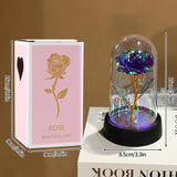 Pink and pale pink foil roses in glass domes on dark bases side by side