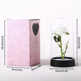 Gold foil rose in a lit glass dome with a note stating batteries are not included