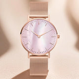 Rose gold mesh watch with pink pearlescent dial and slim hour markers