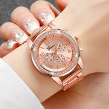 Rose gold rhinestone watch with pale dial worn on a wrist