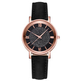 Angled rose gold watch with black dial showing case profile and crown