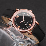 Rose gold watch with black dial, crystal hour markers and black strap