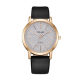 Rose gold case women's watch with pale textured dial and black strap