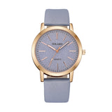 Rose gold watch with grey textured dial and blue grey strap