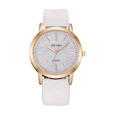 Rose gold women's watch with textured dial and cream white strap