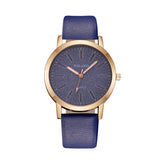 Rose gold women's watch with textured navy dial and navy blue strap
