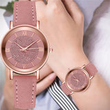 Two rose gold watches with pink dials and pink suede strap shown side by side