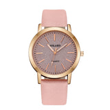 Rose gold case watch with grey textured dial and pink strap on white background