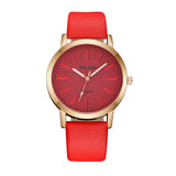 Rose gold case watch with textured red dial and bright red strap