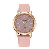 Rose gold watch with textured dial and salmon pink strap on white background