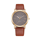Rose gold women's watch with grey textured dial and tan brown strap