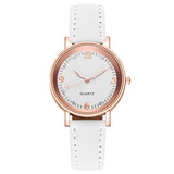 Front view of rose gold watch with pale silver dial and white strap