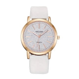 Rose gold women's watch with pale textured dial and white strap