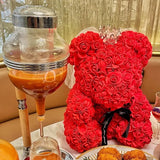 Red foam roses formed into a teddy bear shape on a display stand