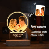 Round photo lamp with gold frame effect showing a couple, names and date on wooden base