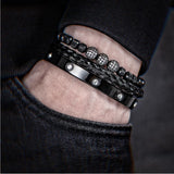 Black beaded bracelet stack with crystal charm worn on wrist