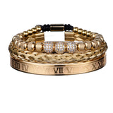 Gold three piece bracelet stack with crystal charm and Roman numeral bar front facing