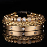 Gold three piece bracelet stack with crystal charm shown on dark background