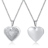 Pair of silver heart lockets with one showing engraved floral detail and one plain