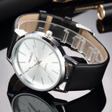 Angled silver mesh watch with white dial showing case profile and crown