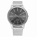 Front view of silver mesh watch with grey dial and slim hour markers