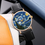 Angled art dial watch with blue and yellow swirling design and black leather strap