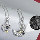 Close-up of silver sun and moon pendant necklaces with projection stone charm
