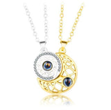 Gold sun and moon pendant necklaces joined together by magnetic closure