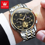 Two-tone blue dial watch with sun moon subdials worn on wrist