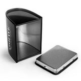 Open black razor travel case beside metal blade storage tin on white background