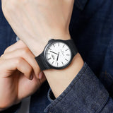 Close-up of the black case white dial sports watch worn on wrist
