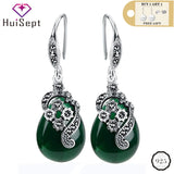 Silver vintage style drop earrings with green teardrop stones and marcasite detail