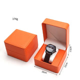 Orange PU leather watch case open displaying a watch inside