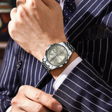 Two-tone gold and silver watch with black dial, day-date window and steel bracelet