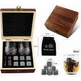 Layout of whiskey gift set contents including box, glasses, granite stones and drawstring pouch
