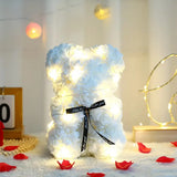 White rose flower teddy bear with black bow and warm LED fairy lights