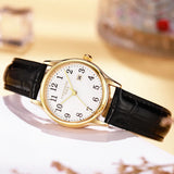 Gold case women's watch with white Arabic numeral dial and black leather strap