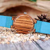 Bamboo watch with turquoise dial and teal strap showing wood grain case