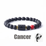 Dark stone bead bracelet with Cancer zodiac charm and red accent bead