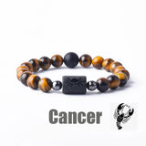 Dark stone bead bracelet with Cancer zodiac symbol charm