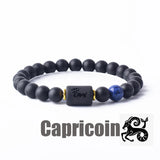 Dark stone bead bracelet with Capricorn zodiac symbol charm