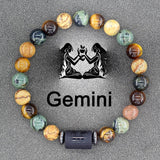 Multicolour natural stone bead bracelet with Gemini zodiac charm on grey