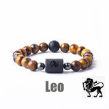 Tiger eye bead bracelet with Leo zodiac symbol bar charm on white background