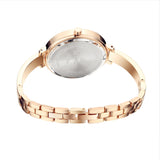 Angled view of slim rose gold women's watch showing ultra thin case profile