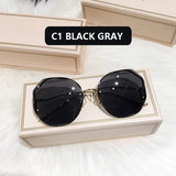 Black frame curved sunglasses with dark gray lens in cream box