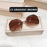 Gold frame curved sunglasses with brown gradient lens in cream box