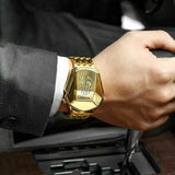 Gold HOURSLY watch worn on a wrist with a dark suit sleeve