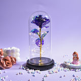 Blue and purple galaxy rose in a glass dome with LED lights on a wooden base